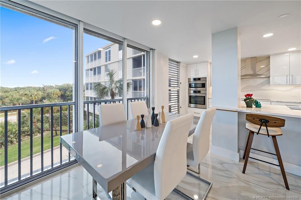 669 Northeast Plantation Road, Unit 201 Stuart, FL 34996 - Photo 16 of 37 a view of a dining room with furniture window and wooden floor