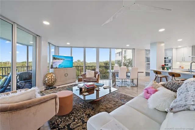 a view of a balcony with chairs and wooden floor