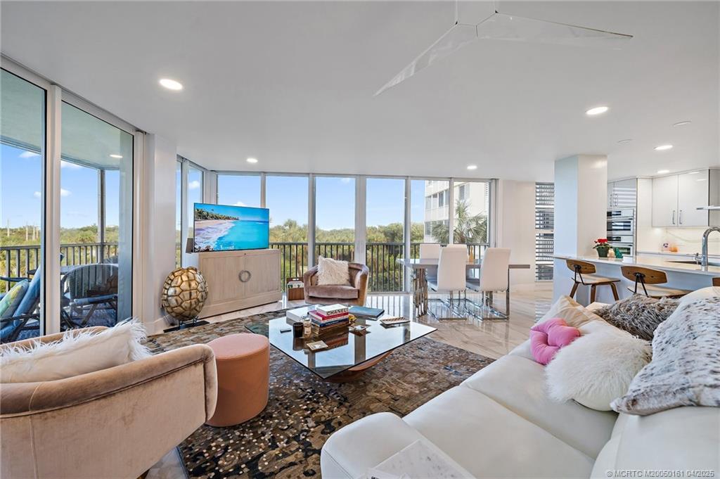 669 Northeast Plantation Road, Unit 201 Stuart, FL 34996 - Photo 19 of 37 a living room with furniture and a large window
