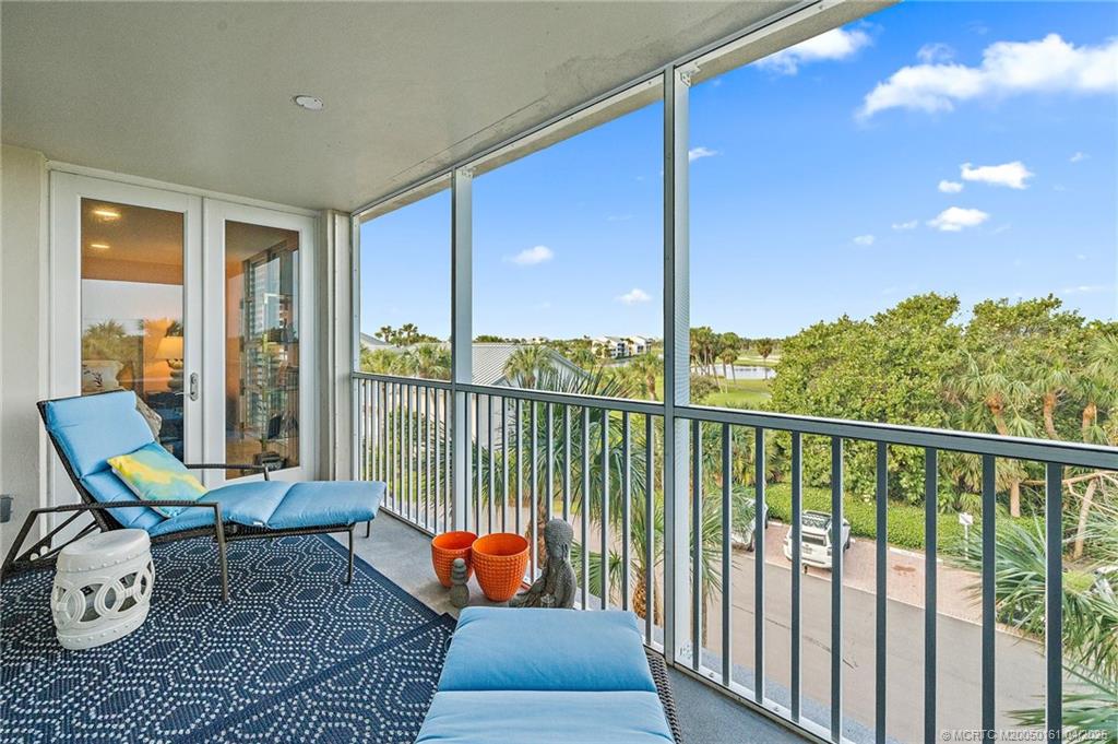669 Northeast Plantation Road, Unit 201 Stuart, FL 34996 - Photo 22 of 37 a balcony with furniture and wooden floor
