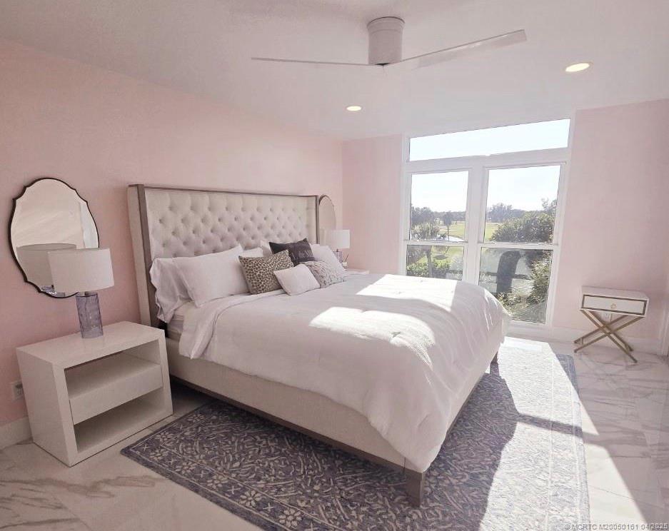 669 Northeast Plantation Road, Unit 201 Stuart, FL 34996 - Photo 25 of 37 a bedroom with bed and a large window