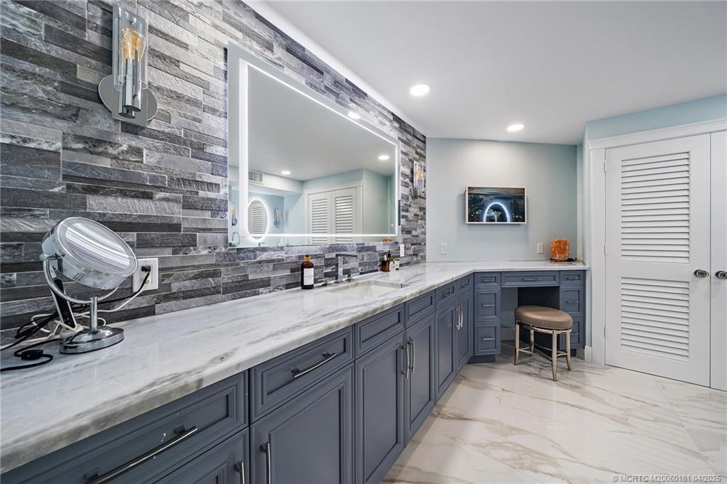 669 Northeast Plantation Road, Unit 201 Stuart, FL 34996 - Photo 26 of 37 a bathroom with a sink and a mirror