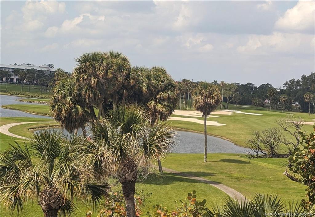 669 Northeast Plantation Road, Unit 201 Stuart, FL 34996 - Photo 34 of 37 a view of a lake from a yard