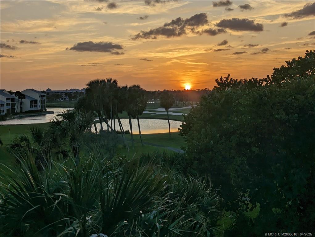 669 Northeast Plantation Road, Unit 201 Stuart, FL 34996 - Photo 35 of 37 a view of a lake with a yard and mountain view