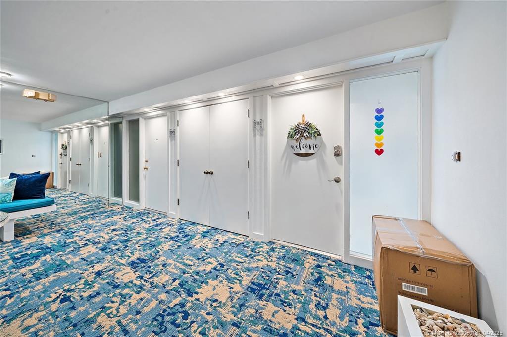 669 Northeast Plantation Road, Unit 201 Stuart, FL 34996 - Photo 7 of 37 a view of a livingroom with wooden floor and a refrigerator