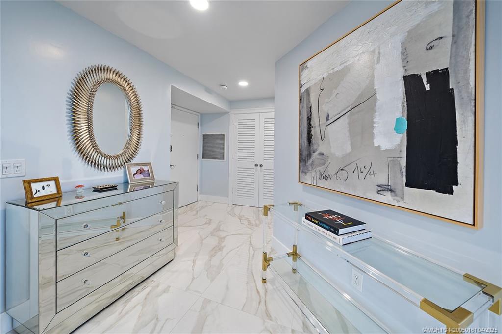 669 Northeast Plantation Road, Unit 201 Stuart, FL 34996 - Photo 8 of 37 a spacious bathroom with a double vanity sink and a mirror