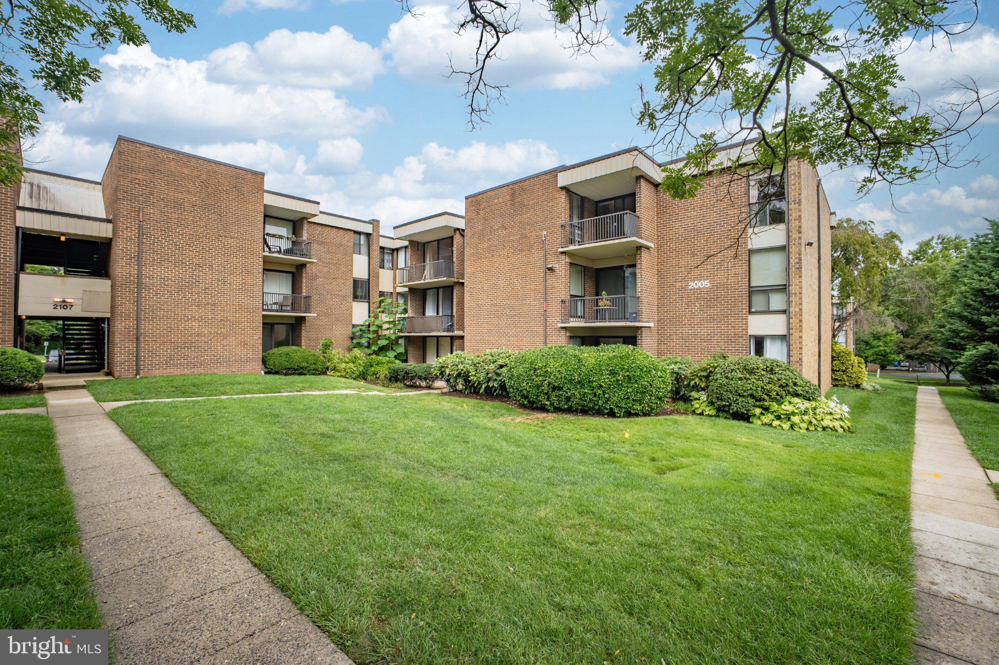 2005 Coleridge Drive, Unit 13101 Silver Spring, MD 20902 - Photo 14 of 16 Charming brick apartments in lush greenery.
