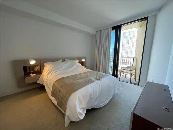 a bed sitting in a bedroom next to a window