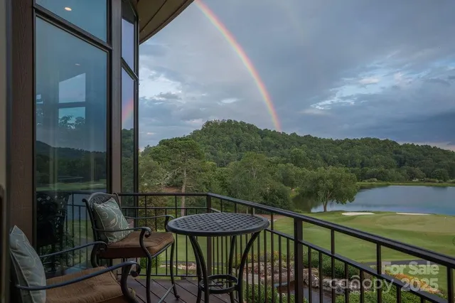 a view of a chairs and table in the balcony