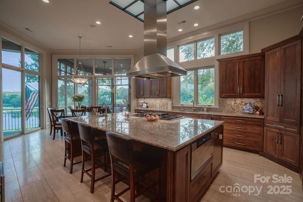 15 Water View Court Travelers Rest, SC 29690 - Photo 13 of 48 a kitchen with a stove a sink dishwasher and a dining table with garden view