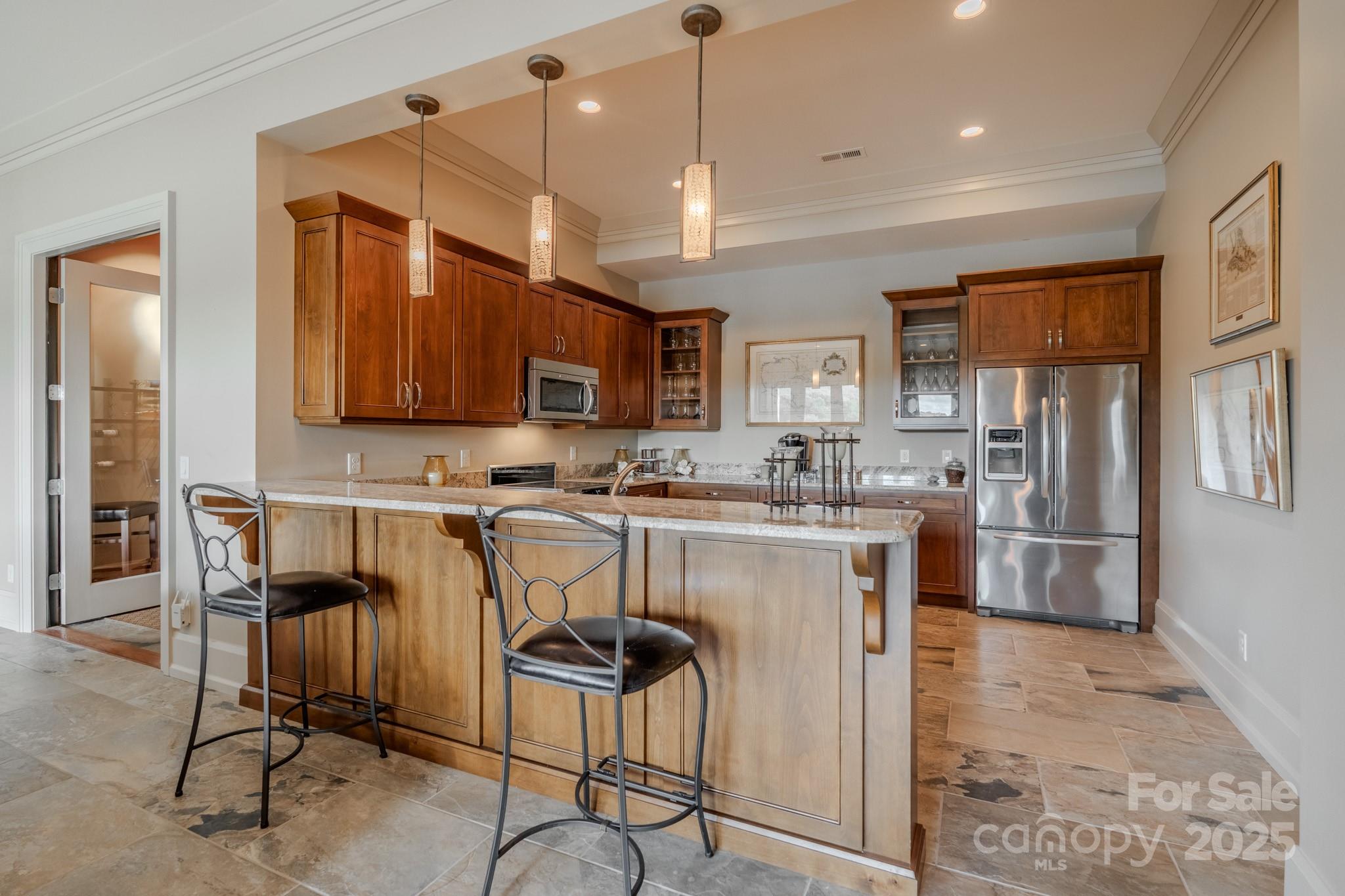 15 Water View Court Travelers Rest, SC 29690 - Photo 31 of 48 a kitchen with stainless steel appliances granite countertop a stove top oven a refrigerator a sink and chairs