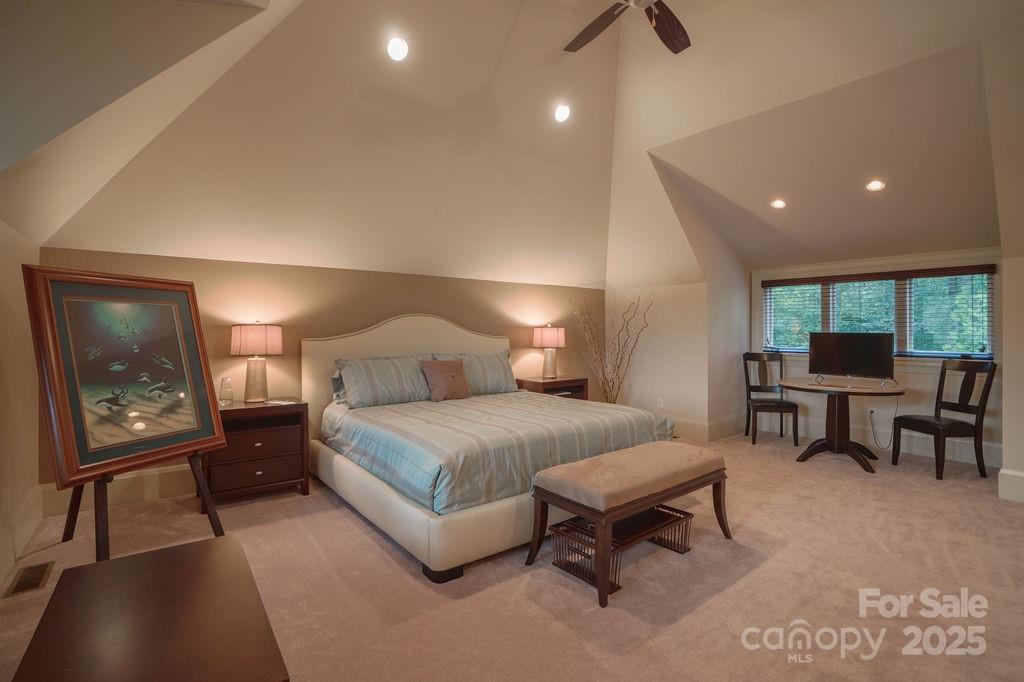 15 Water View Court Travelers Rest, SC 29690 - Photo 37 of 48 a spacious bedroom with a bed a table and painting on the wall