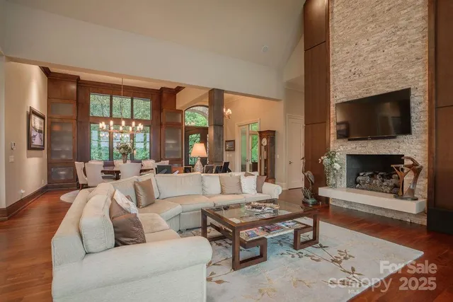 a living room with fireplace furniture and a flat screen tv