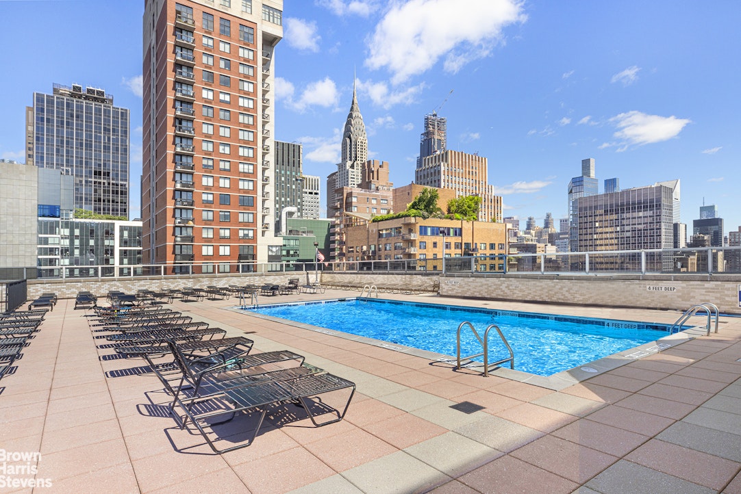 300 East 40th Street, Unit 12P Manhattan, NY 10016 - Photo 7 of 13 a view of a swimming pool with outdoor seating
