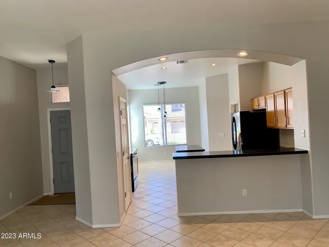 a view of a hallway with wooden floor and a living room