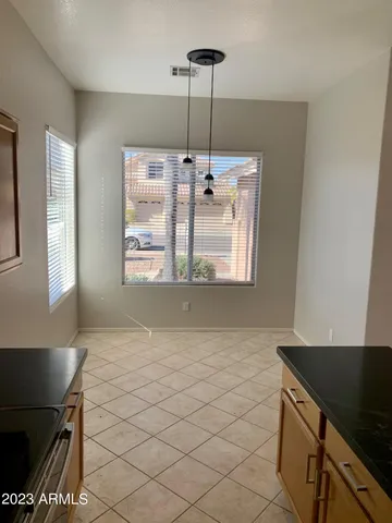 a view of kitchen with granite countertop cabinets and a stove top oven