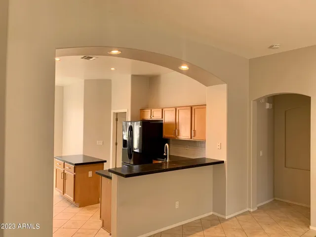 a kitchen with stainless steel appliances a refrigerator and microwave