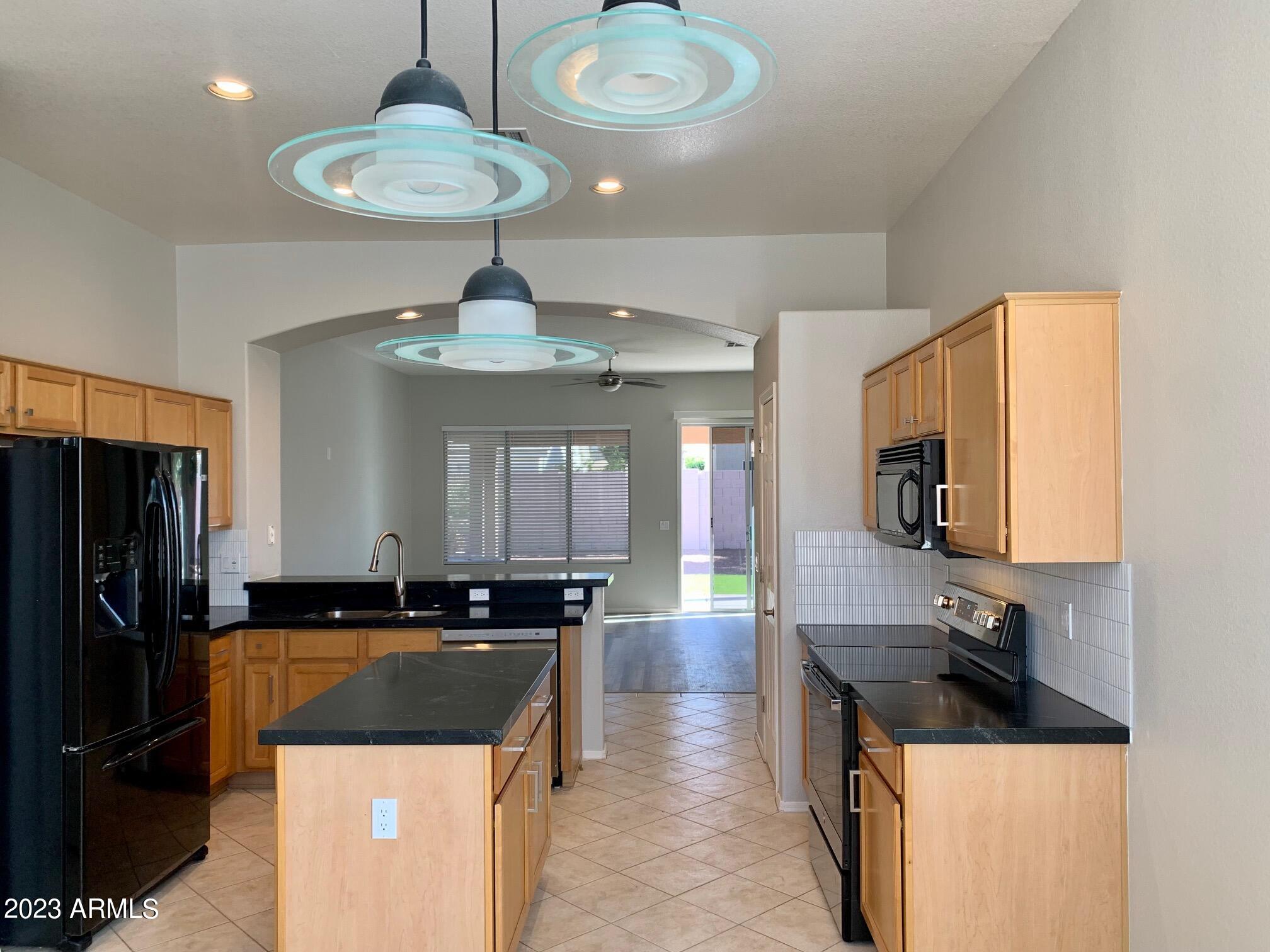 1655 East Harrison Street Chandler, AZ 85225 - Photo 6 of 35 a kitchen with a sink a refrigerator and a stove