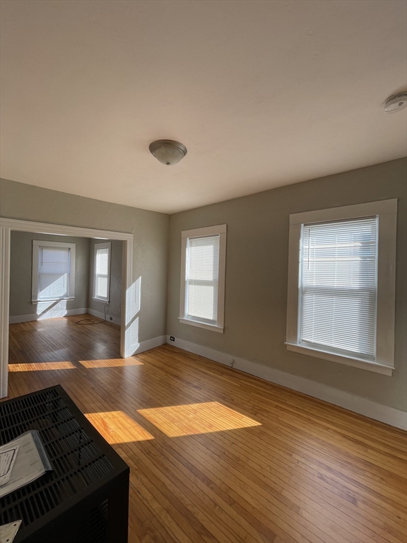 5 Freeland Terrace Worcester, MA 01603 - Photo 25 of 35 an empty room with wooden floor and windows
