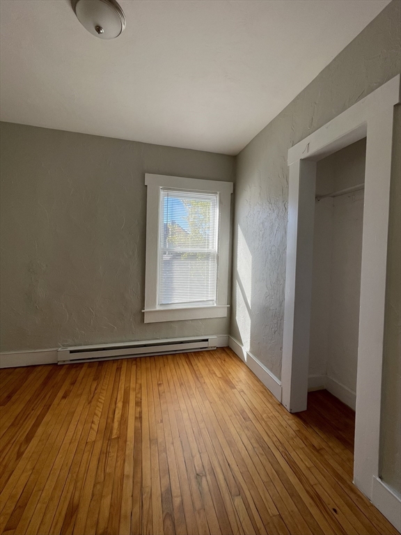 5 Freeland Terrace Worcester, MA 01603 - Photo 29 of 35 an empty room with wooden floor and windows