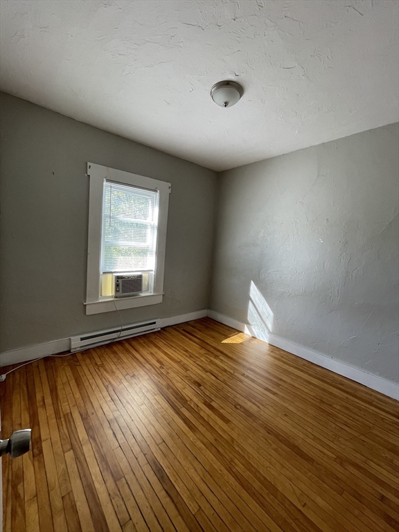 5 Freeland Terrace Worcester, MA 01603 - Photo 30 of 35 an empty room with wooden floor and windows