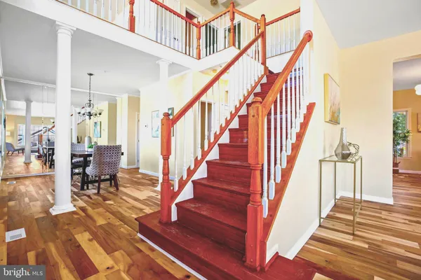 a view of entryway and hall with wooden floor