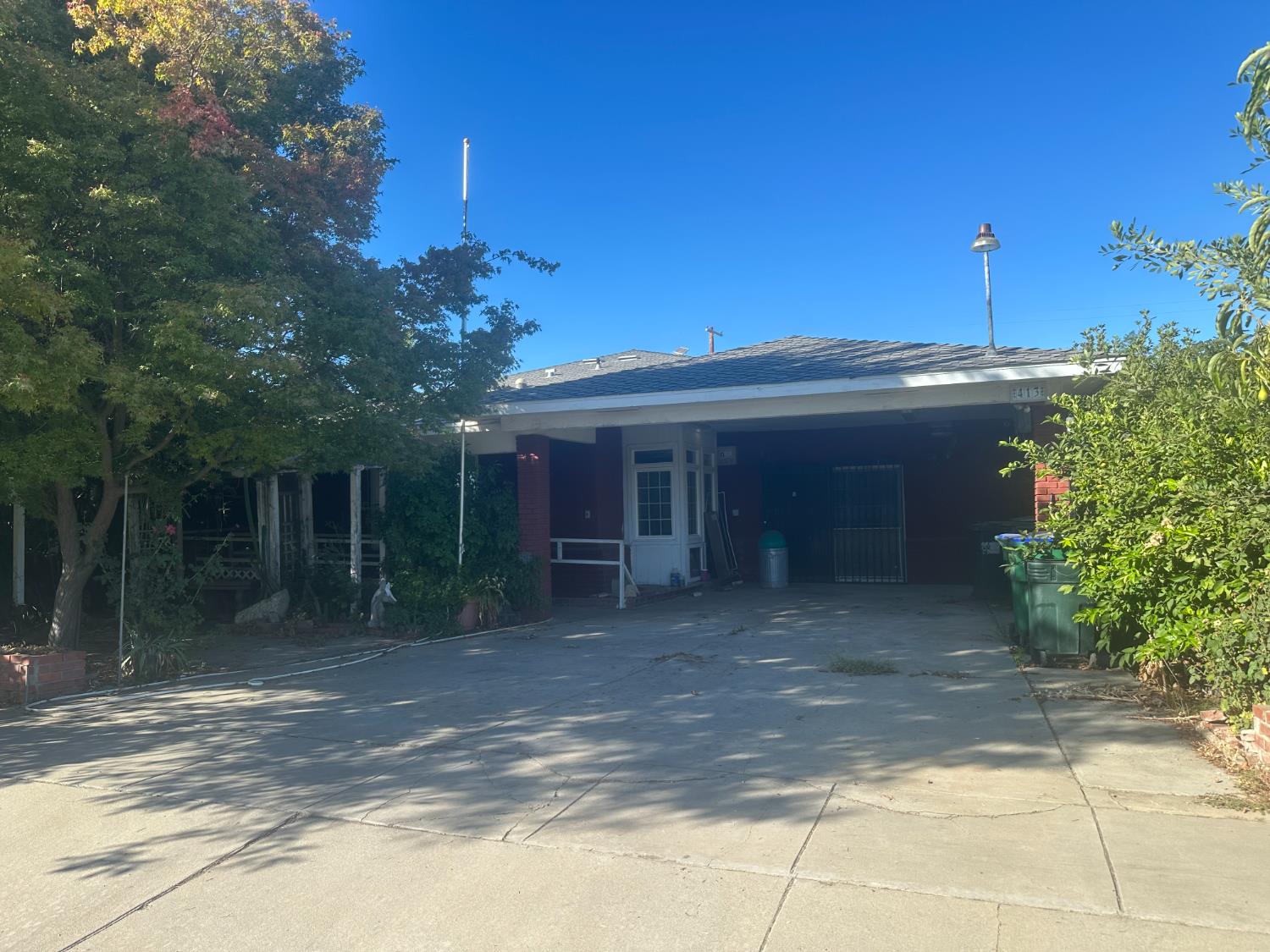 a front view of a house with plants