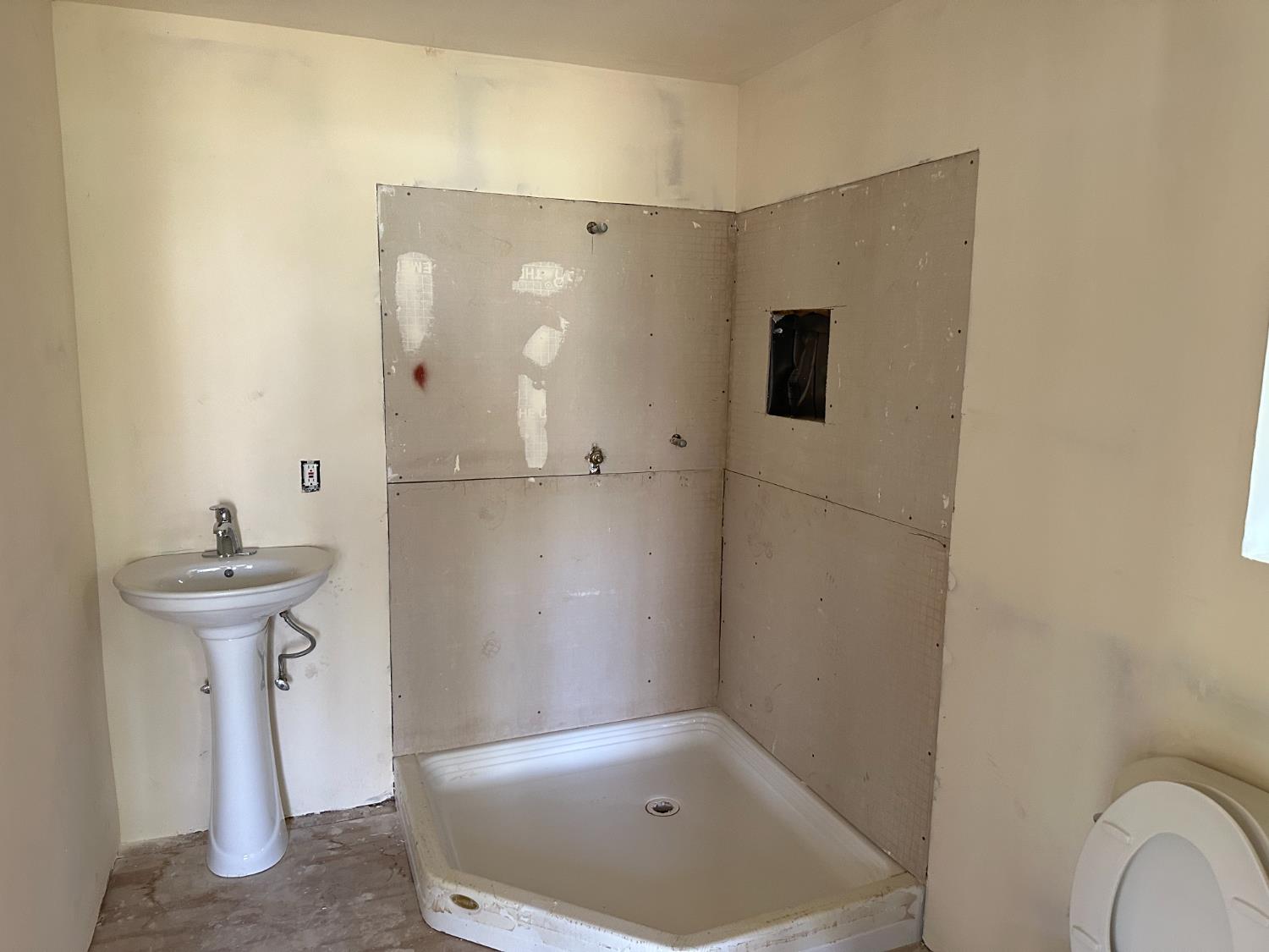 413 South 5th Street Fowler, CA 93625 - Photo 14 of 18 a bathroom with a sink and shower