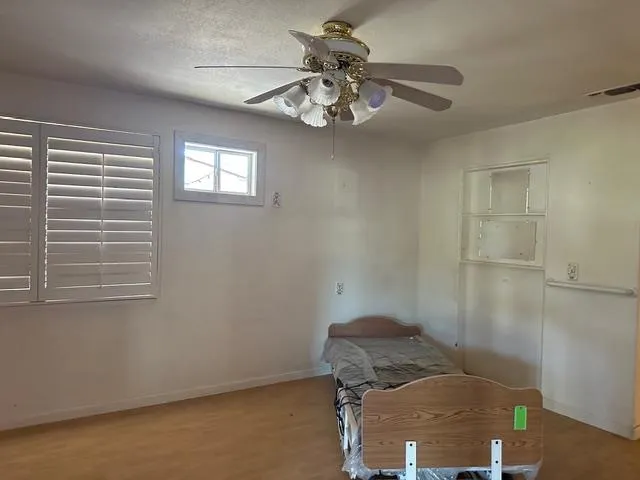 a bedroom with a bed and a window