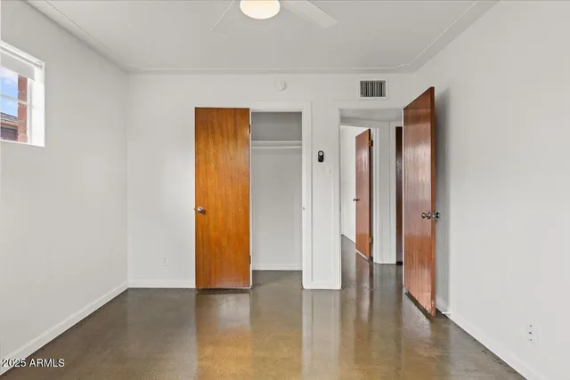 a view of a hallway with wooden floor