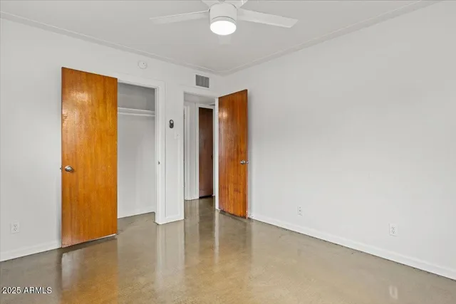 an empty room with wooden floor and closet