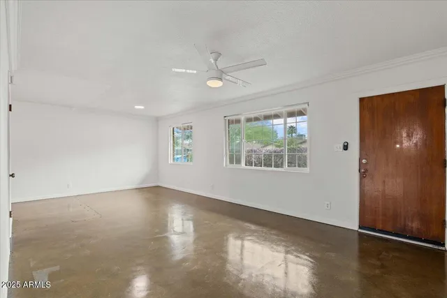 an empty room with windows and closet