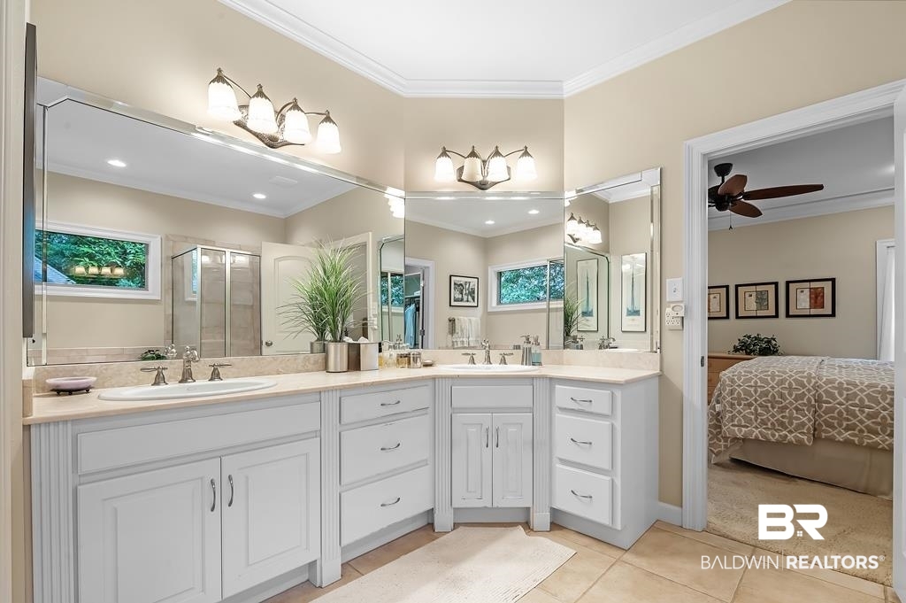 29976 Dolive Ridge Daphne, AL 36527 - Photo 33 of 58 Bathroom featuring double sink vanity, tile patterned flooring, plenty of natural light, and ceiling fan