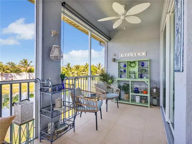 a balcony with furniture and a potted plant