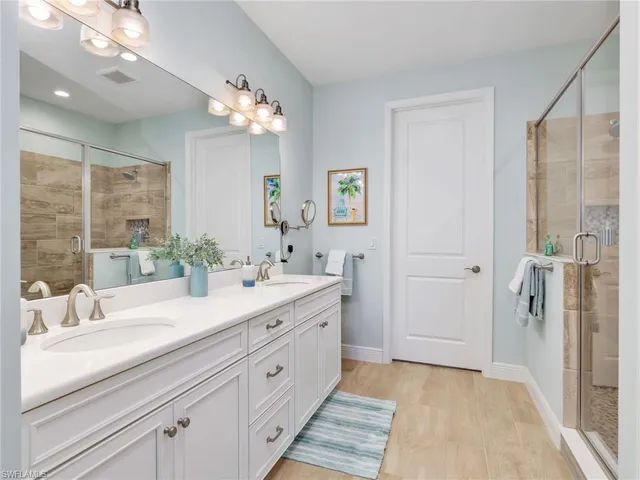a bathroom with a sink double vanity and a shower
