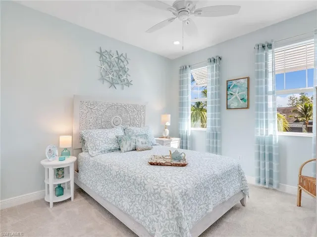 a bedroom with a bed and a lamp on a dresser