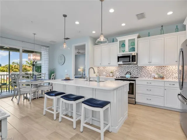 a large kitchen with kitchen island granite countertop a large island in the center