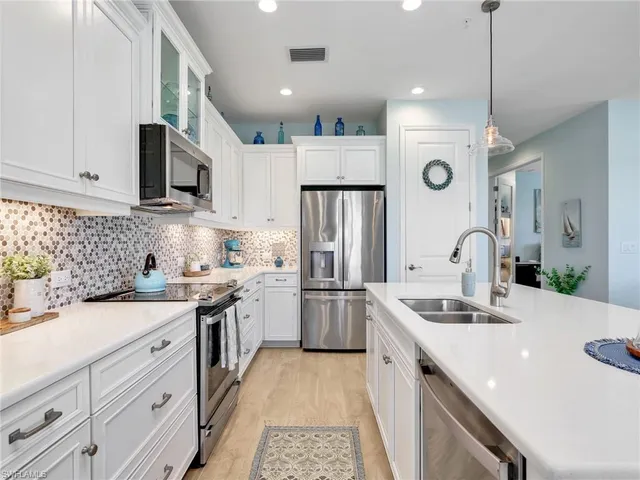 a kitchen with a sink stove and refrigerator