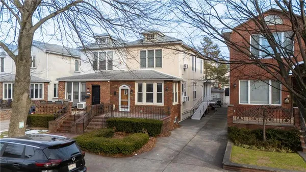a front view of a house with a garden
