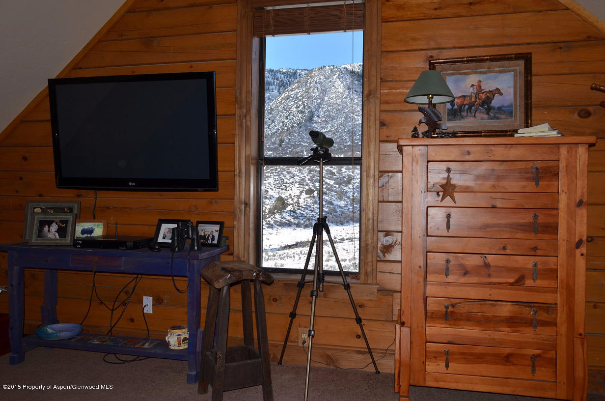 142 Happy Dog Trail Rifle, CO 81650 - Photo 12 of 39 a living room with furniture and a flat screen tv