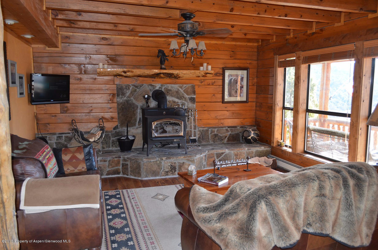 142 Happy Dog Trail Rifle, CO 81650 - Photo 16 of 39 a bed sitting in a bedroom next to a window