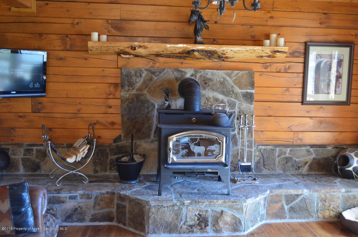 142 Happy Dog Trail Rifle, CO 81650 - Photo 17 of 39 a fireplace with wooden floor