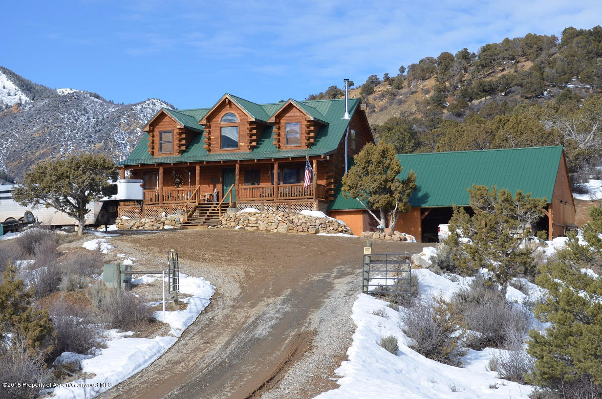 142 Happy Dog Trail Rifle, CO 81650 - Photo 2 of 39 a front view of a house with a yard