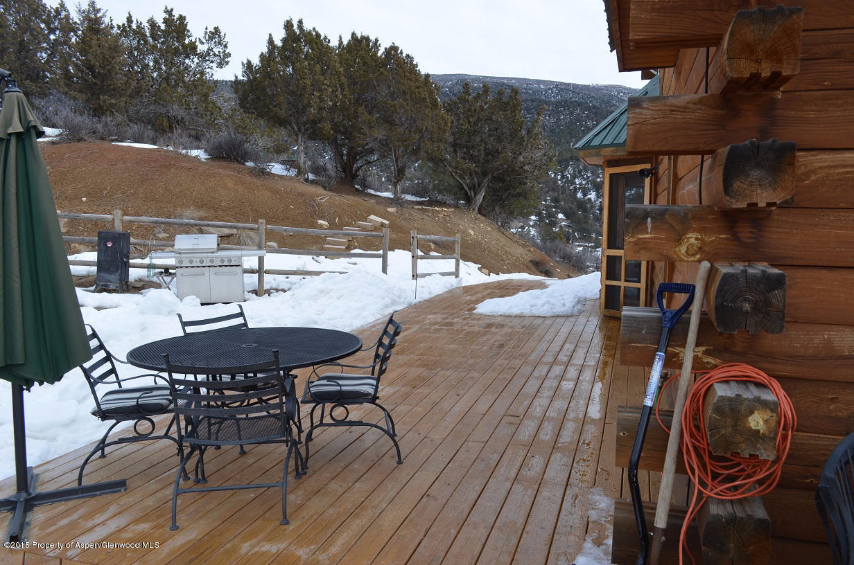 142 Happy Dog Trail Rifle, CO 81650 - Photo 21 of 39 a view of a patio with table and chairs with wooden floor and fence