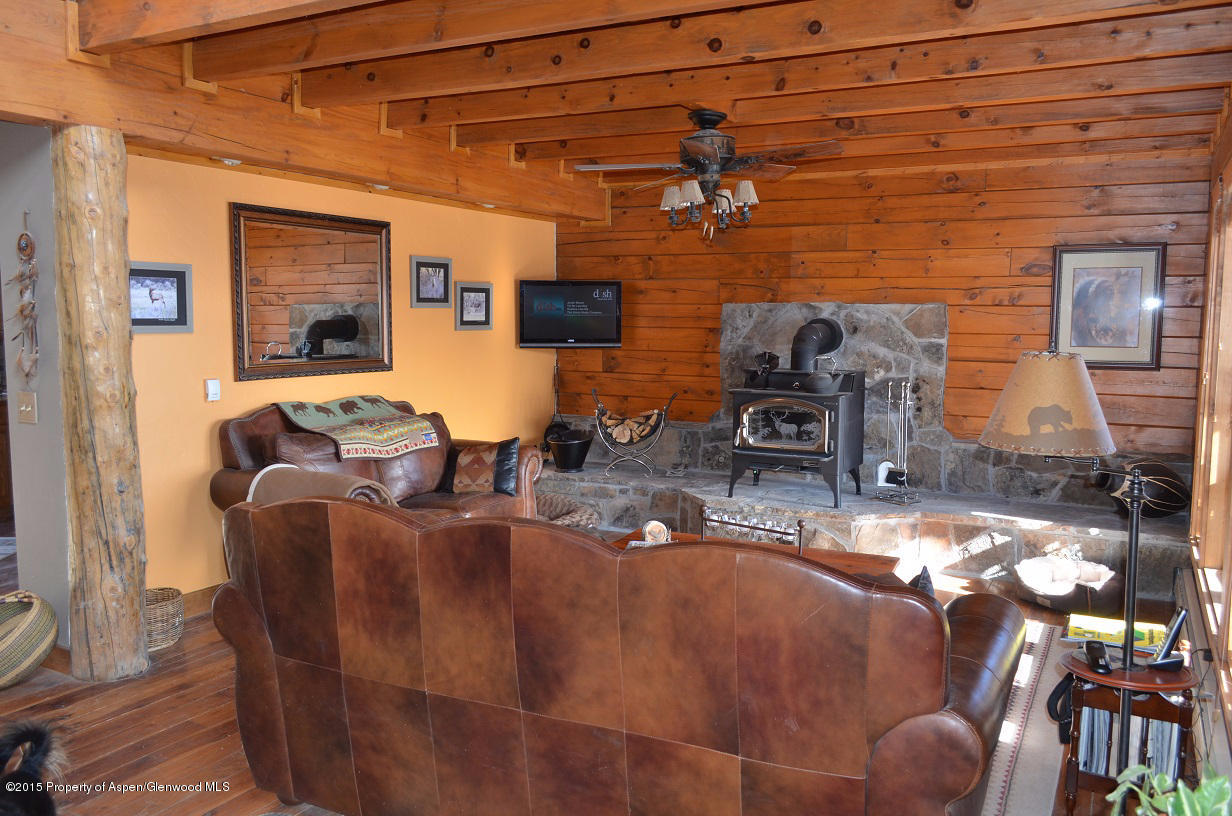 142 Happy Dog Trail Rifle, CO 81650 - Photo 5 of 39 a living room with furniture a flat screen tv and a fireplace