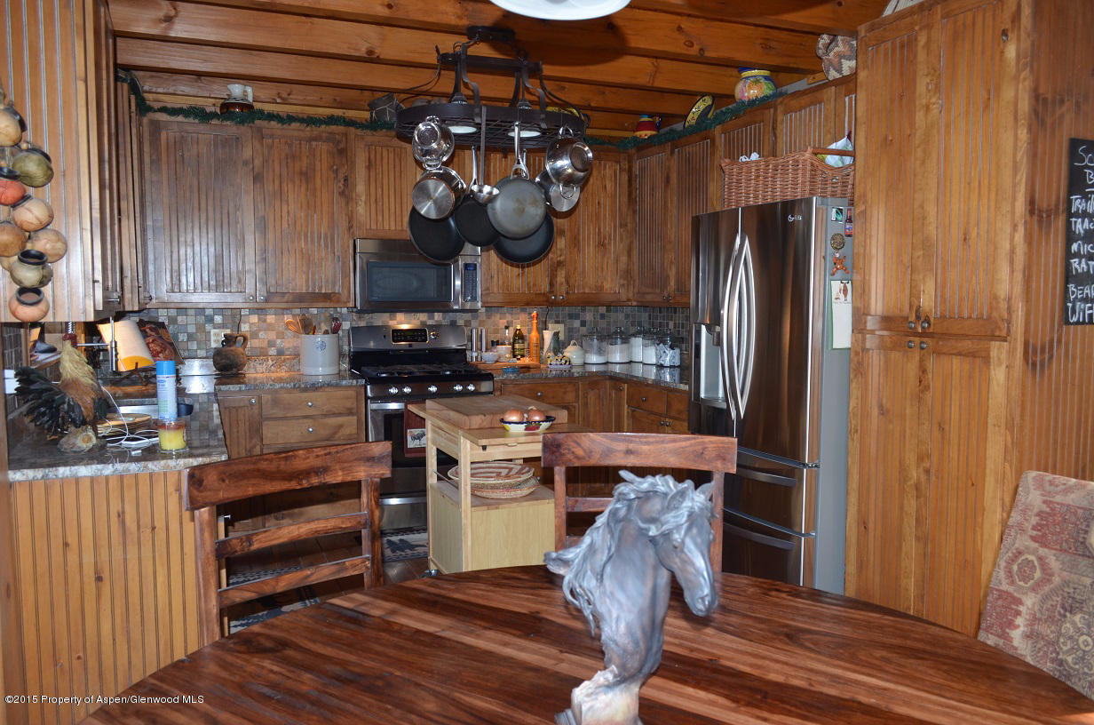 142 Happy Dog Trail Rifle, CO 81650 - Photo 8 of 39 a kitchen with stainless steel appliances granite countertop a refrigerator and a stove top oven
