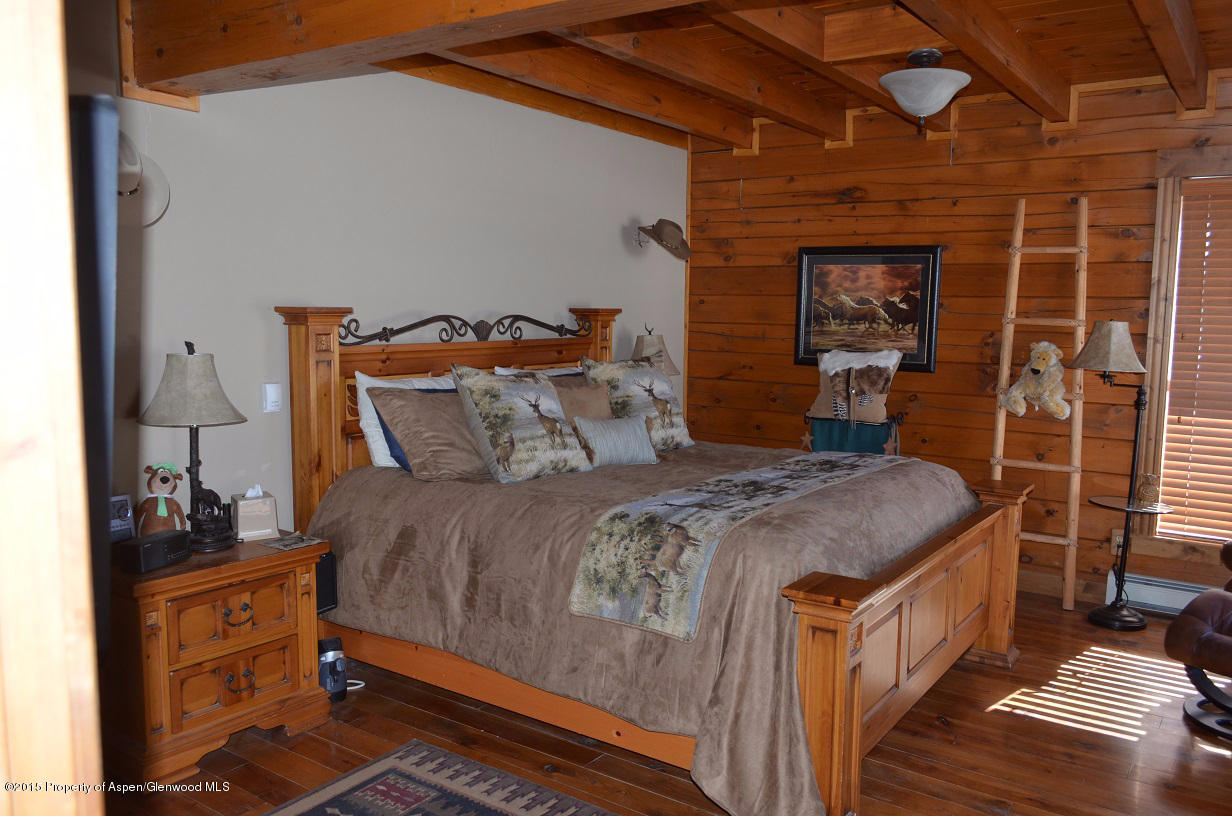 142 Happy Dog Trail Rifle, CO 81650 - Photo 9 of 39 a bedroom with a bed and a mirror