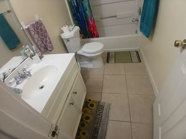 a bathroom with a sink toilet and a mirror