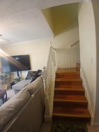 a living room with furniture and a stair