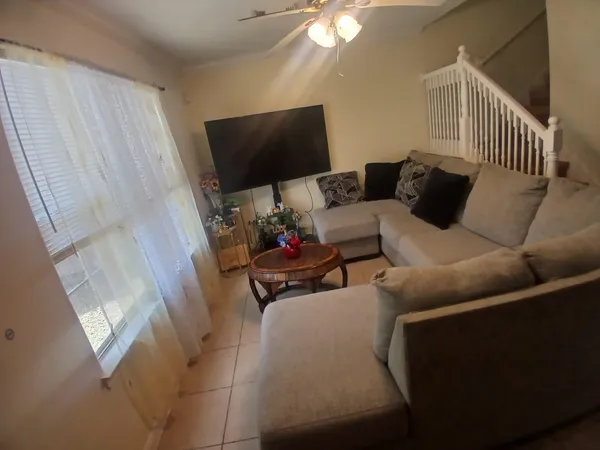 a living room with furniture and a flat screen tv